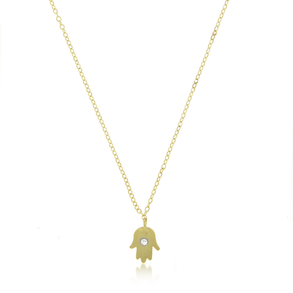 yellow gold hamsa hand necklace with centered diamond bezel