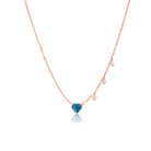 rose gold necklace with blue topaz heart and side pearl charms