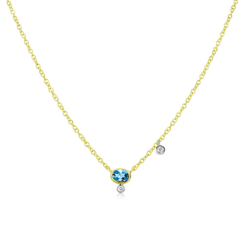 dainty yellow gold necklace with centered blue topaz and diamond