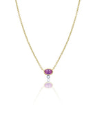 yellow gold necklace with centered pink sapphire and diamond bezel